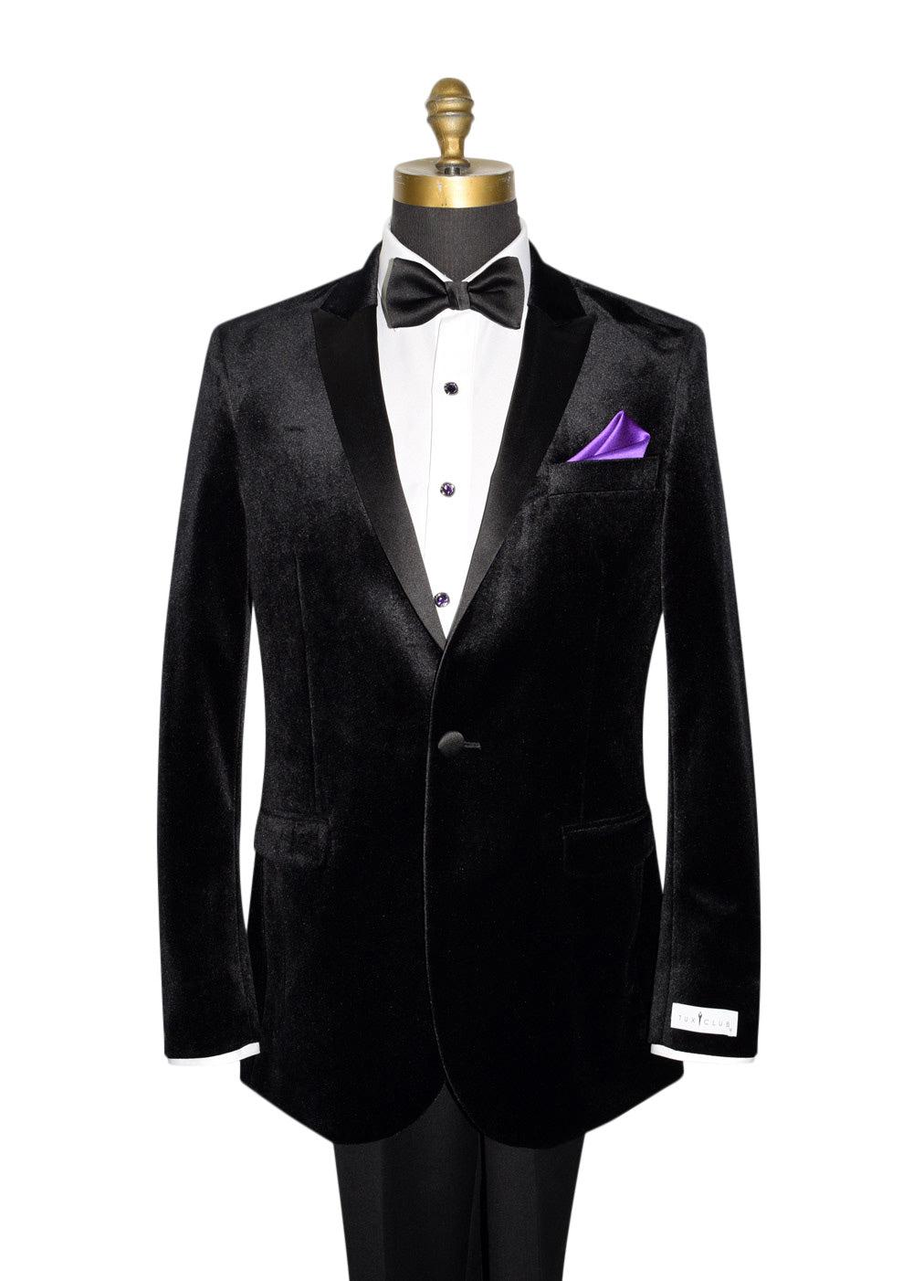 Close-up Black Velvet tuxedo with black bowtie and purple pocket handkerchief against a white background by tuxclub  