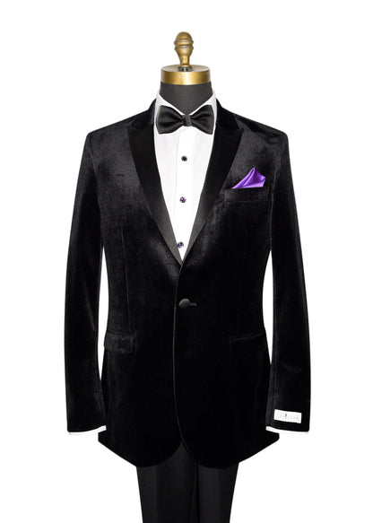 Close-up Black Velvet tuxedo with black bowtie and purple pocket handkerchief against a white background by tuxclub  