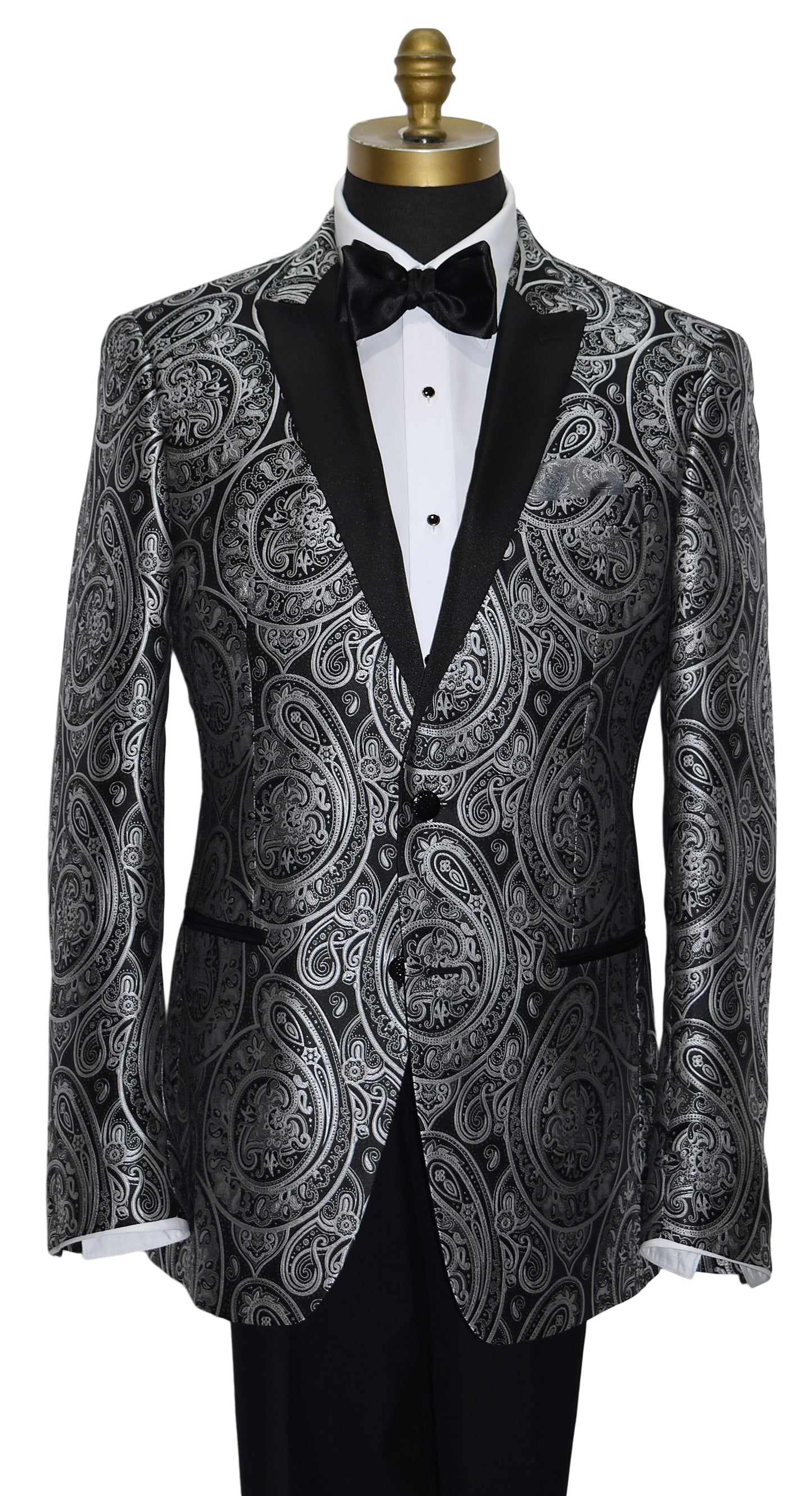 close-up  mannequin wearing a black tuxedo with silver paisley with black tuxedo pants and a black satin bowtie against a white background