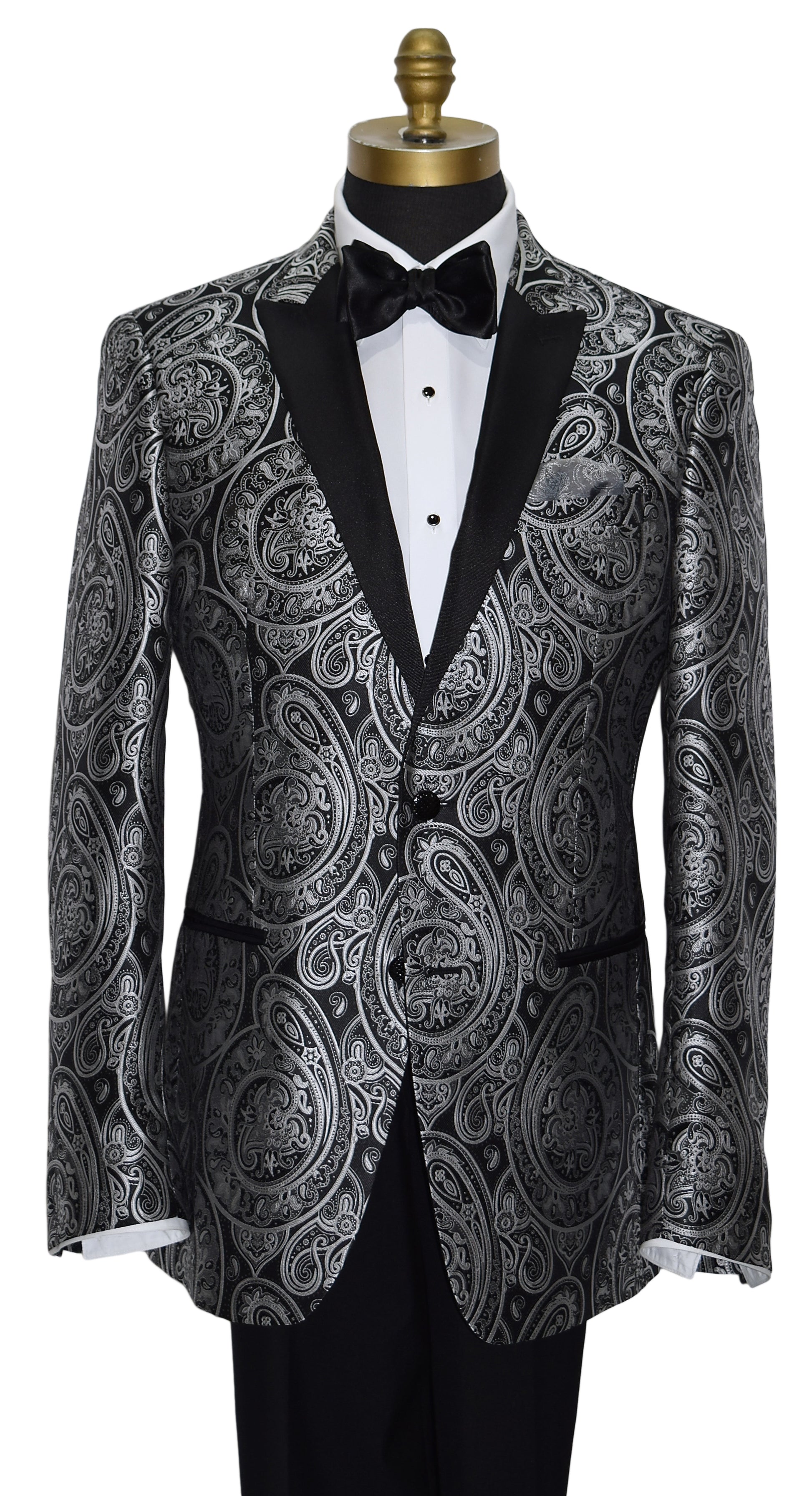 close-up  mannequin wearing a black tuxedo with silver paisley with black tuxedo pants and a black satin bowtie against a white background