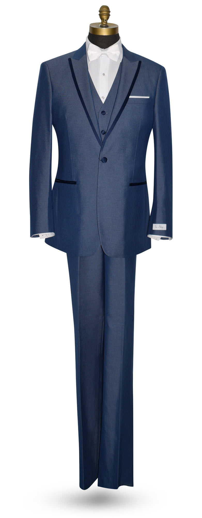 Blue peak lapel tuxedo with a white bowtie against a white background.
