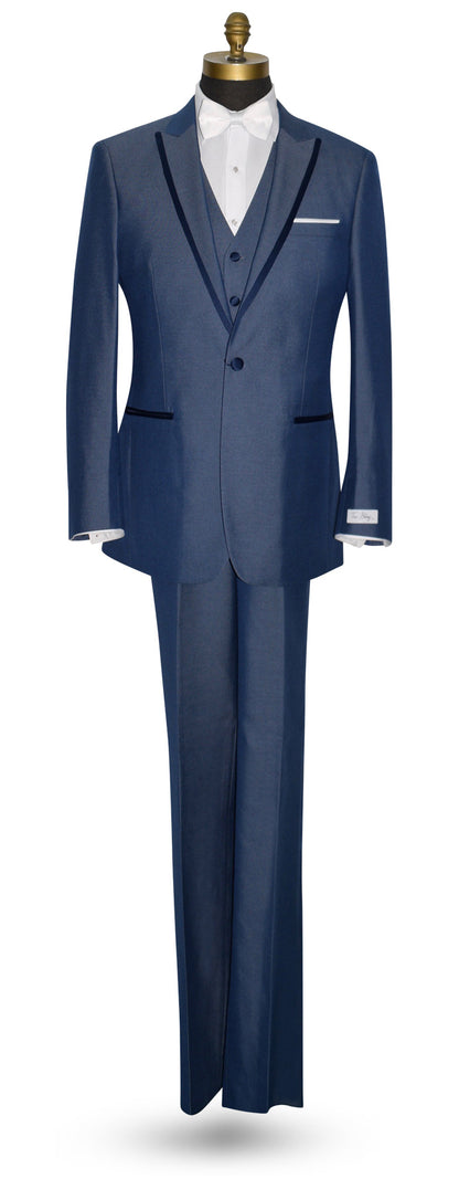 Blue peak lapel tuxedo with a white bowtie against a white background.