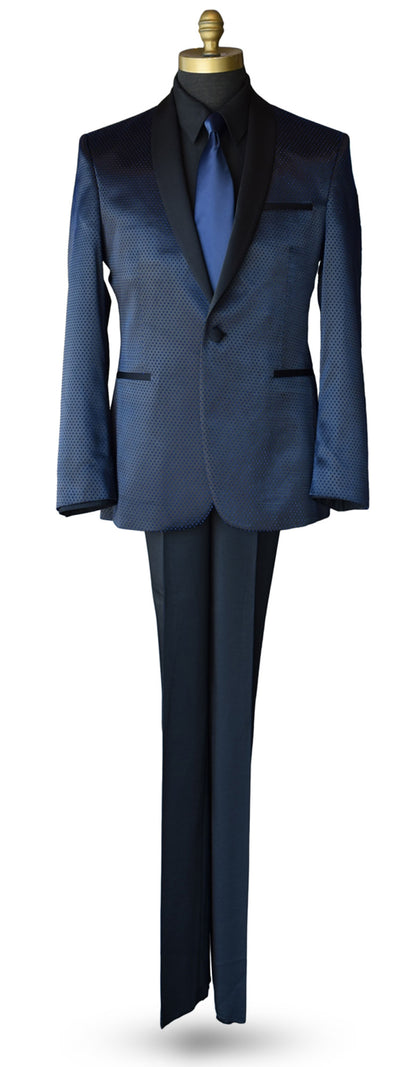 Life size mannequin wearing a blue shawl collar tuxedo with a black tuxedo shirt and long blue necktie against a white background
