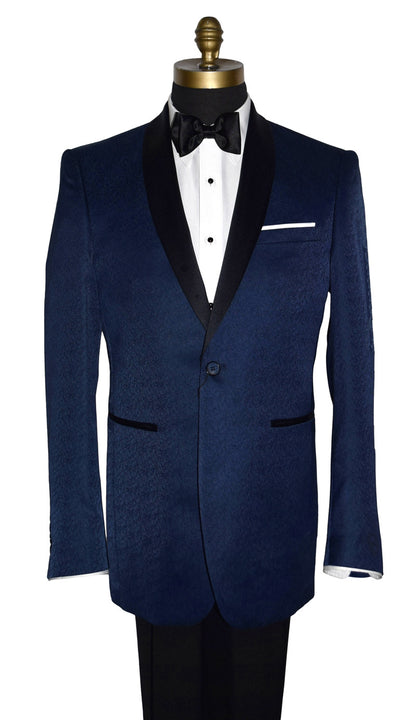 close-up Navy blue tuxedo with black shawl collar with a brocade print on a mannequin with black tuxedo pants and a white tuxedo shirt and black satin bowtie in front of a white background