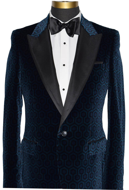 close-up mannequin wearing a blue hexagon velvet tuxedo jacket with a white tuxedo shirt and a black satin tie-yourself bowtie against a white background