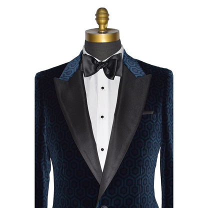 very close-up mannequin wearing a blue hexagon velvet tuxedo jacket with a white tuxedo shirt and a black satin tie-yourself bowtie against a white background