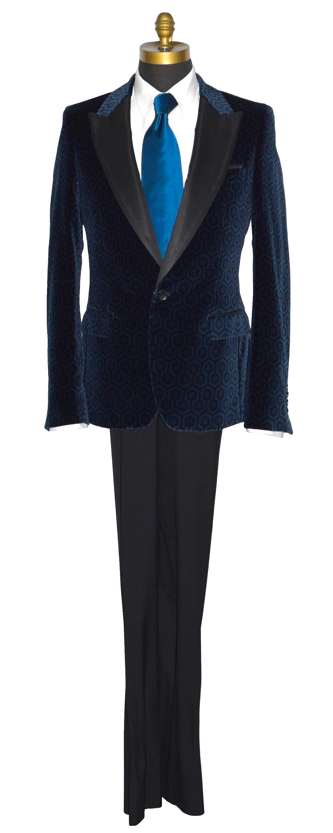 life size mannequin wearing a blue hexagon velvet tuxedo jacket with a white tuxedo shirt and a long blue silk necktie against a white background