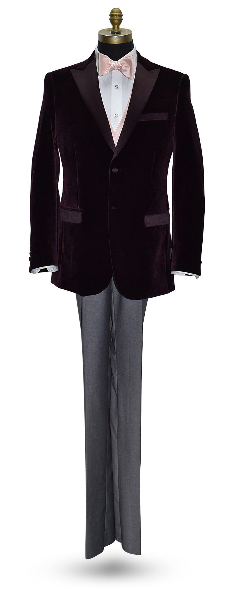 life size mannequin wearing a wine color velvet dinner jacket wearing a blush "tie-yourself" bowtie and a blush tuxedo vest with gray pants against a white background