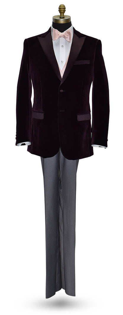 life size mannequin wearing a wine color velvet dinner jacket wearing a blush "tie-yourself" bowtie and a blush tuxedo vest with gray pants against a white background