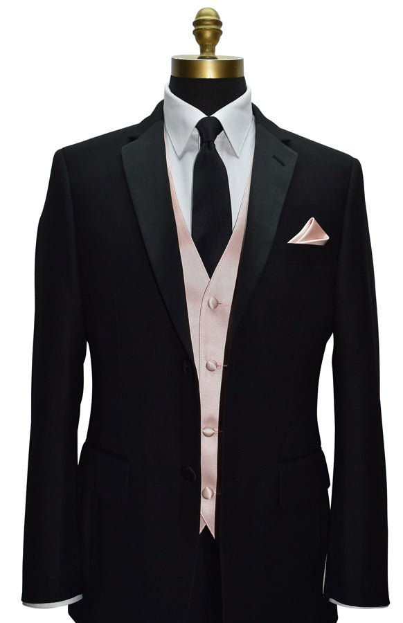 close-up black tuxedo wearing a blush tuxedo vest with a black satin necktie against a white background