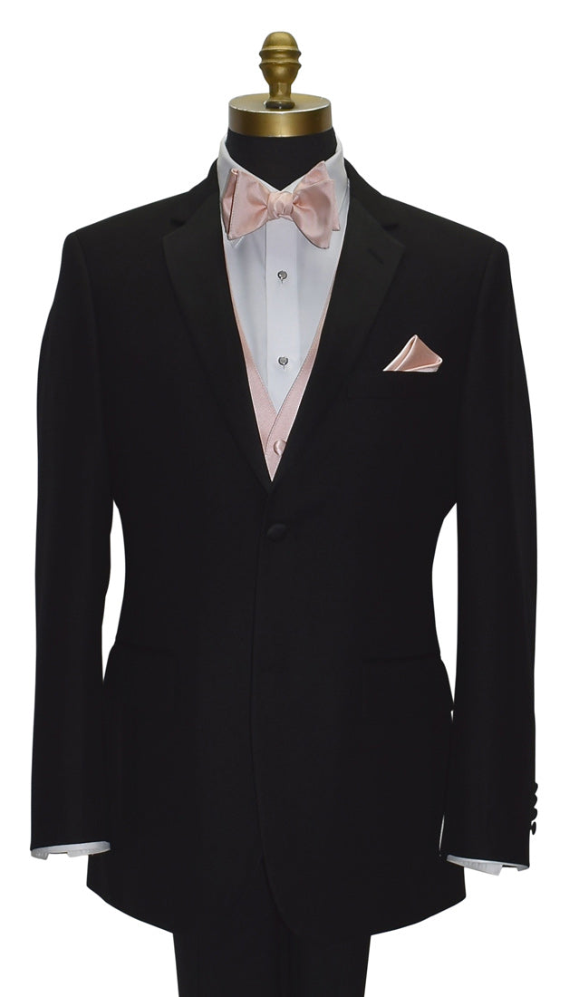 close-up mannequin wearing a black notch-lapel tuxedo with a white dress shirt and a blush tuxedo vest with a blush "tie-yourself" bowtie against a white background