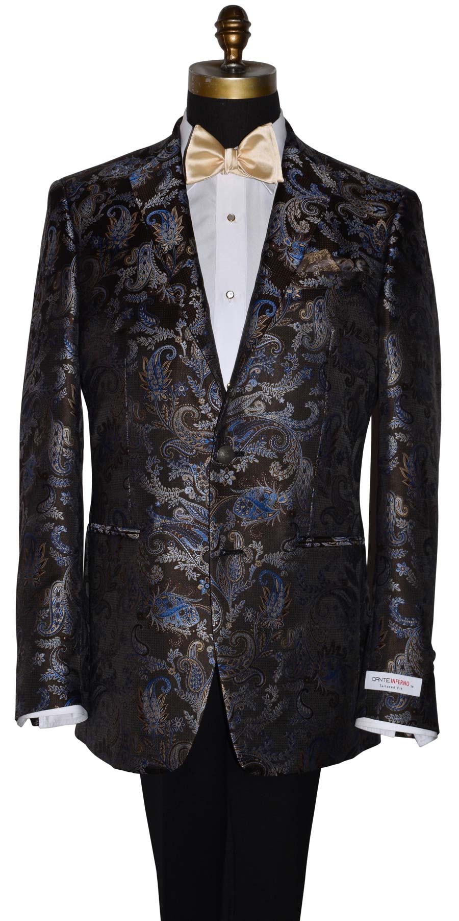 Close up of mannequin wearing a brown and blue paisley suit jacket with a champagne colored bowtie against a white background