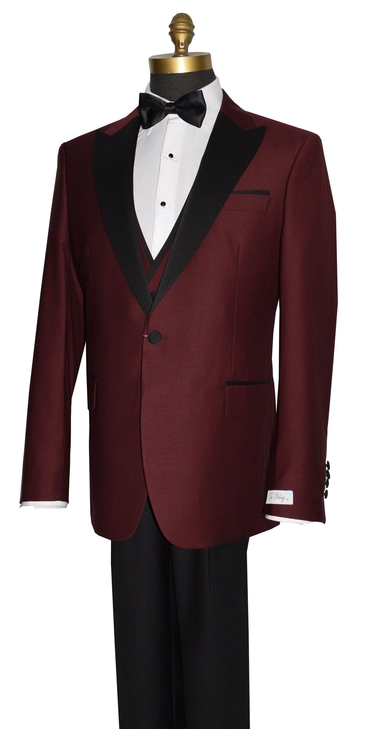 side view close-up burgundy 3 piece tuxedo with black lapels on a mannequin with a black bow tie against a white background