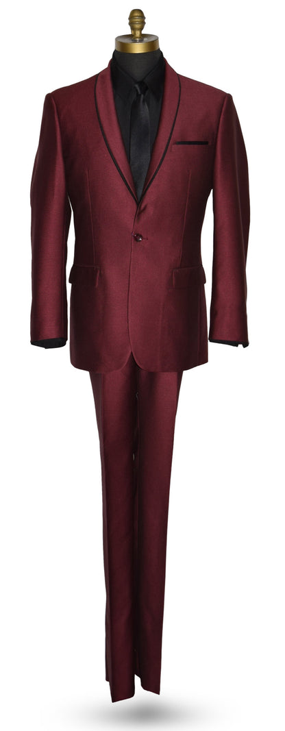 Burgundy shawl collar tuxedo with a black shirt and long black necktie on a mannequin against a white background