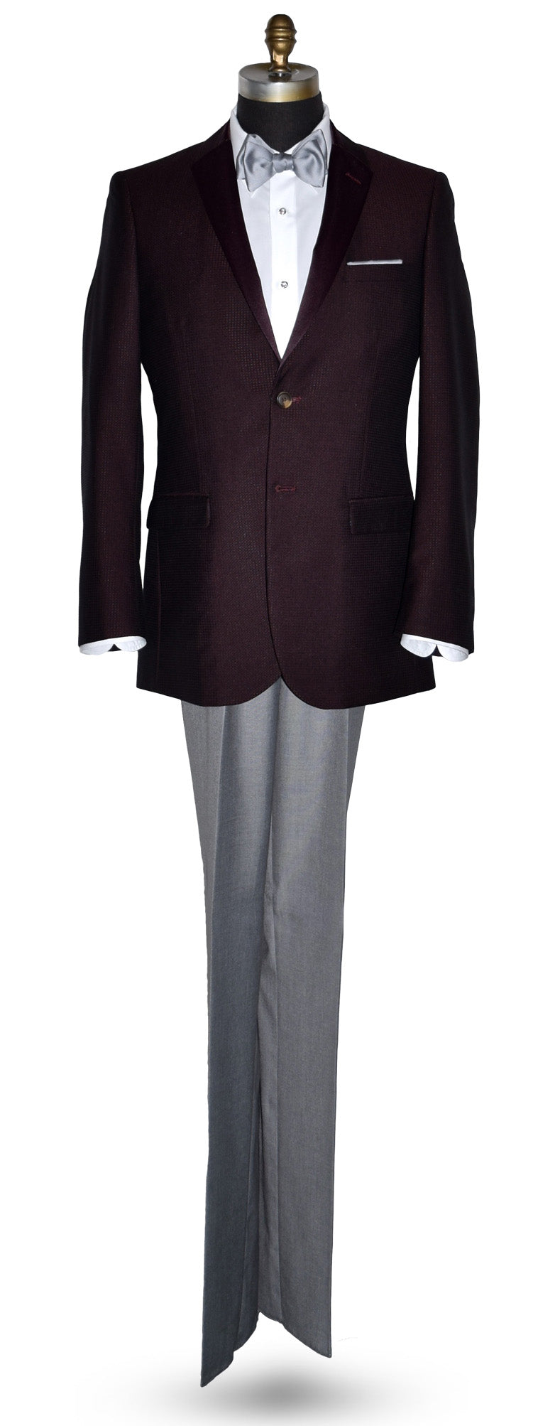 Burgundy tuxedo jacket with burgundy lapels on a mannequin with gray pants