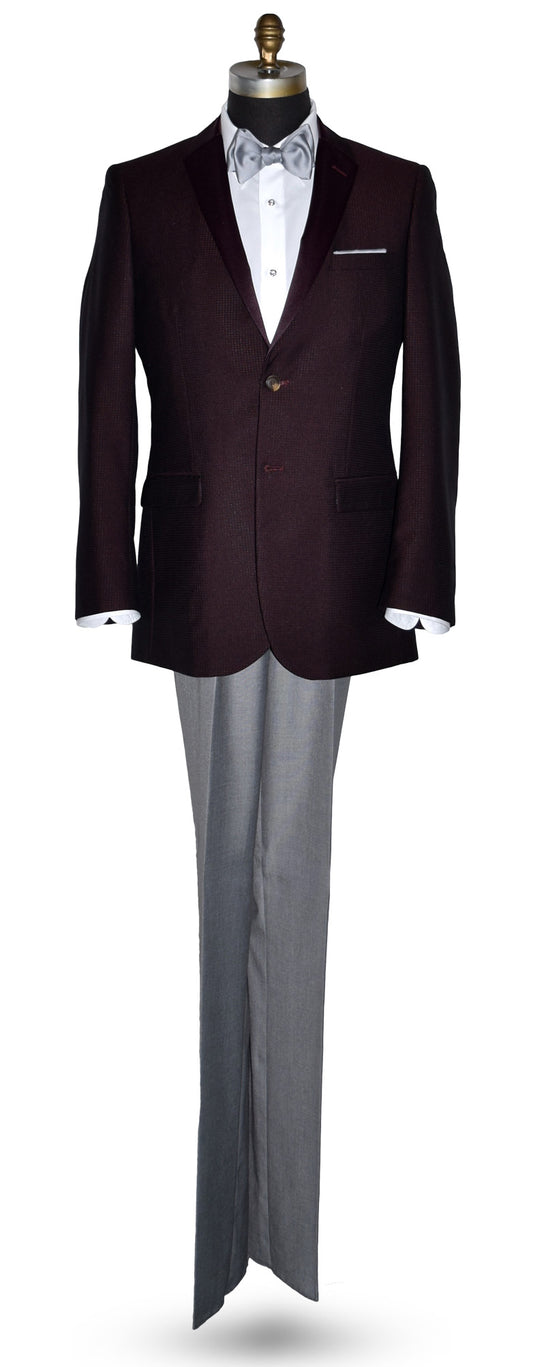 Burgundy tuxedo jacket with burgundy lapels on a mannequin with gray pants
