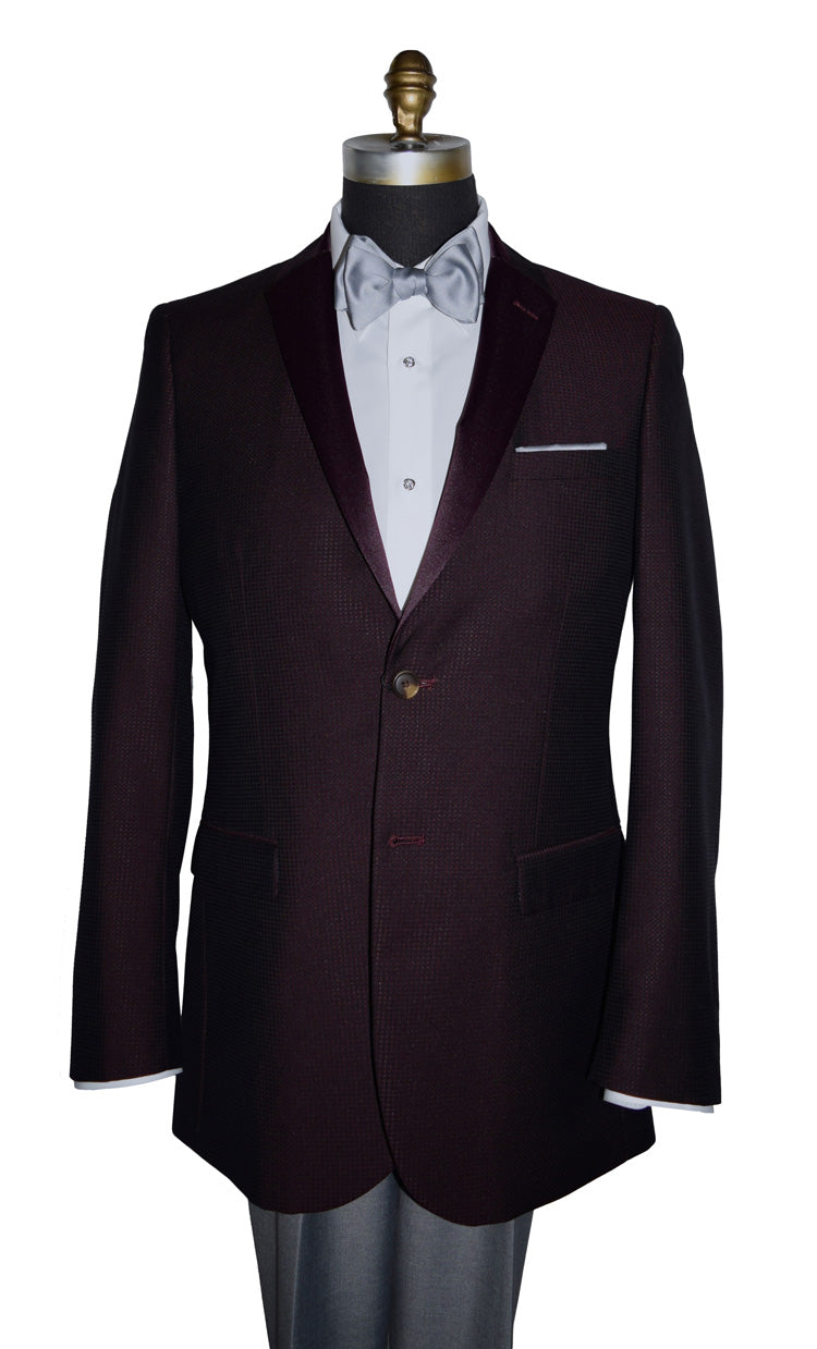 close-up burgundy tuxedo jacket with burgundy satin notch lapel with a gray bowtie and gray pants against a white background