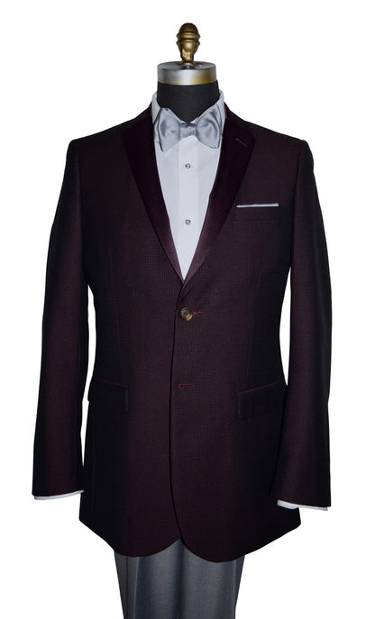 close-up burgundy tuxedo jacket with burgundy satin notch lapel with a gray bowtie and gray pants against a white background