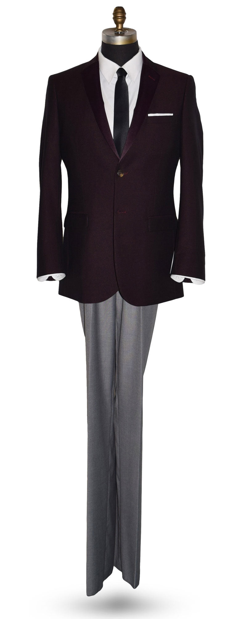 life size mannequin wearing a burgundy tuxedo jacket with a white tuxedo shirt and a long black skinny necktie against a white background