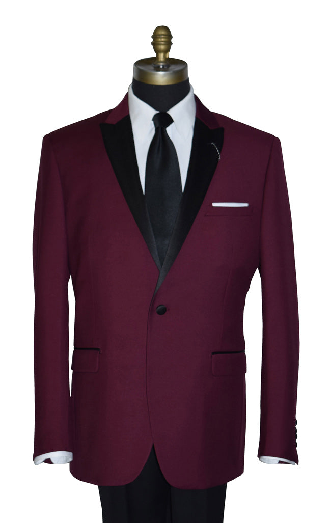 close-up burgundy tuxedo with black pants on a mannequin with a black necktie against a white background