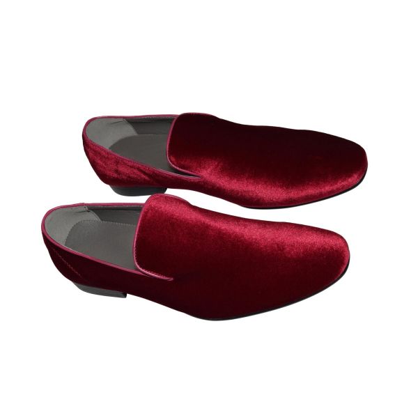 close-up men's burgundy velvet slip-on shoes against a white background