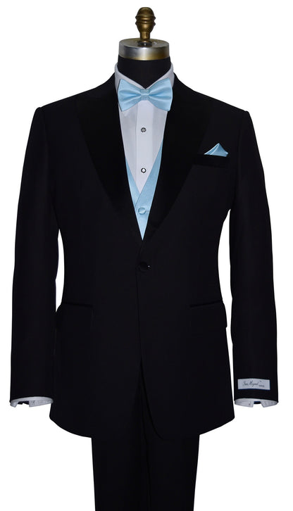 close-up front view-mannequin wearing a "San Miguel Especial" black peak-lapel tuxedo with a white dress shirt and a capri-blue tuxedo vest and  capri-blue "pre-tied" bowtie and pocket handkerchief against a white background