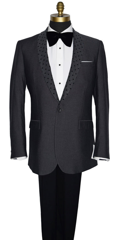 close-up life size mannequin wearing a charcoal gray dinner jacket with a white shirt and larger black velvet bow tie on a mannequin against a white background