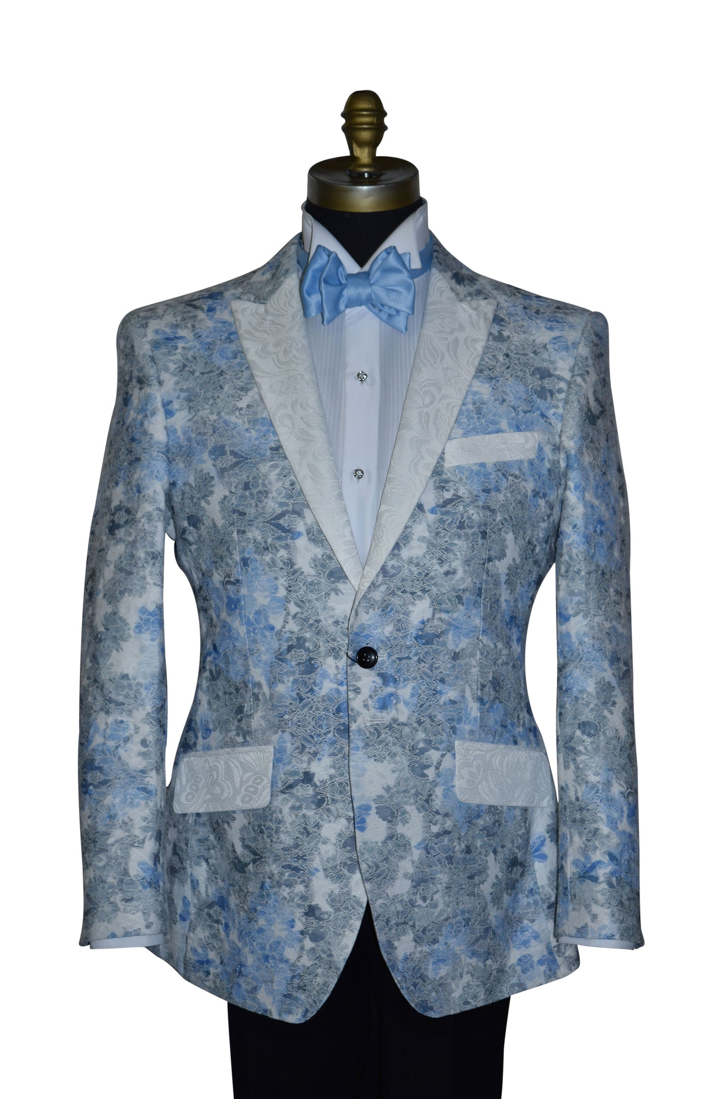 close-up Blue and gray tuxedo with a blue tie-yourself bow tie and crystal studs and cufflinks on a mannequin against a white background