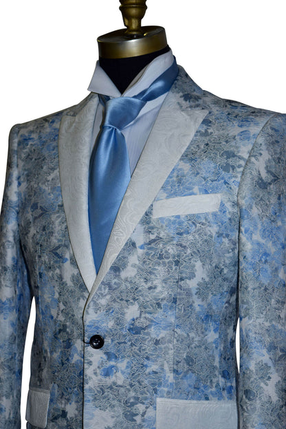 close-up Blue floral patterned tuxedo jacket on a mannequin with a long baby-blue necktie against a white background