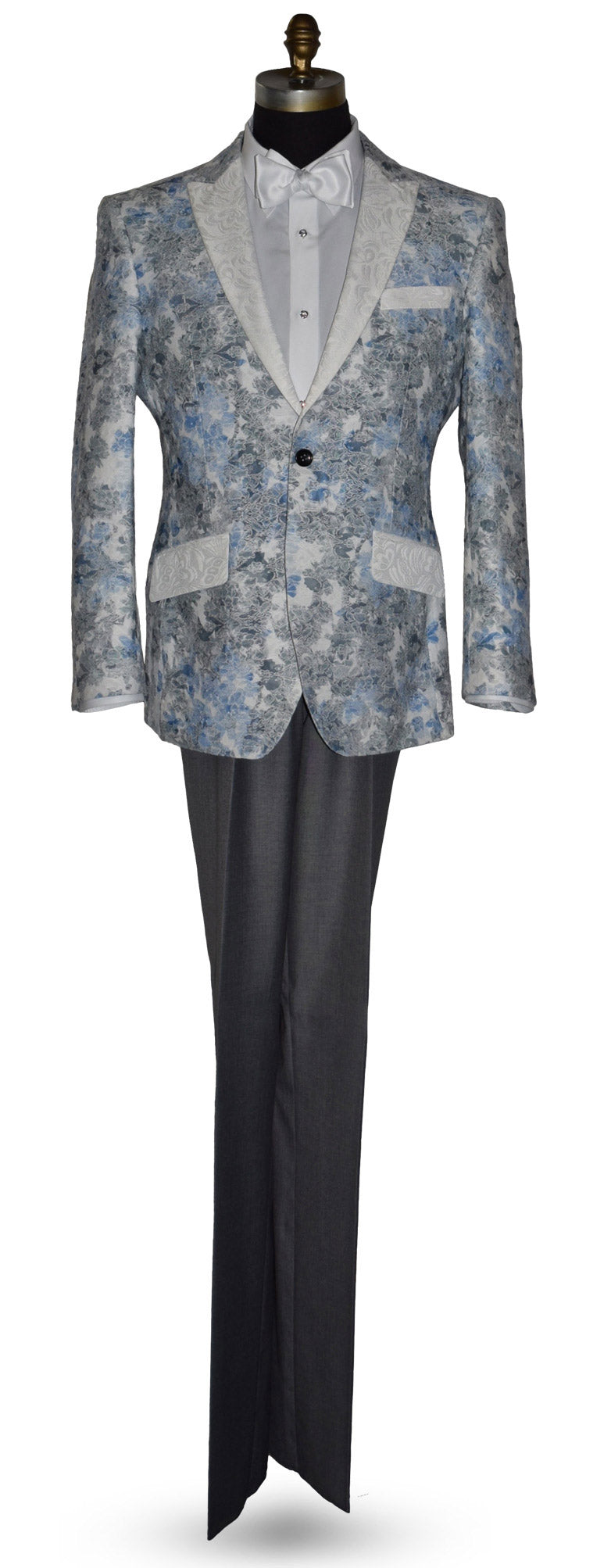 blue and gray floral-patterned tuxedo jacket with a white bowtie and gray pants on a mannequin against a white background