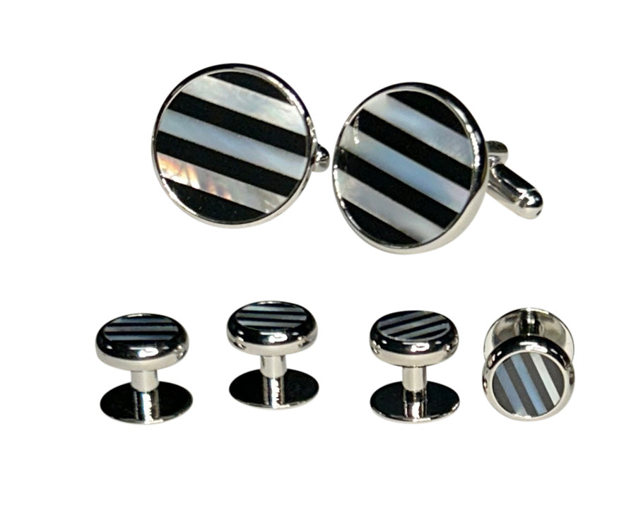 Set of onyx and nother-of-pearl inlayed cufflinks and studs on a white background