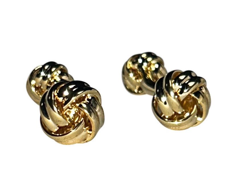 Pair of gold "love-knot" cufflinks on a white background