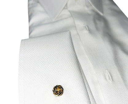 Close-up of a white shirt with a gold love-knot cufflinks on a white background