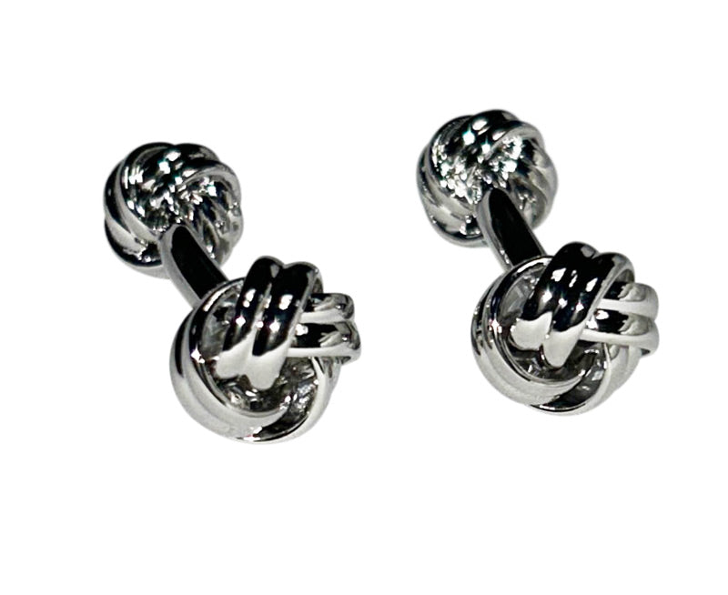 Pair of silver "love-knot" cufflinks on a white background