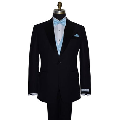 front view Black tuxedo with "San Miguel Especial" branded label wearing a capri-blue bow tie and pocket square on a mannequin against a white background