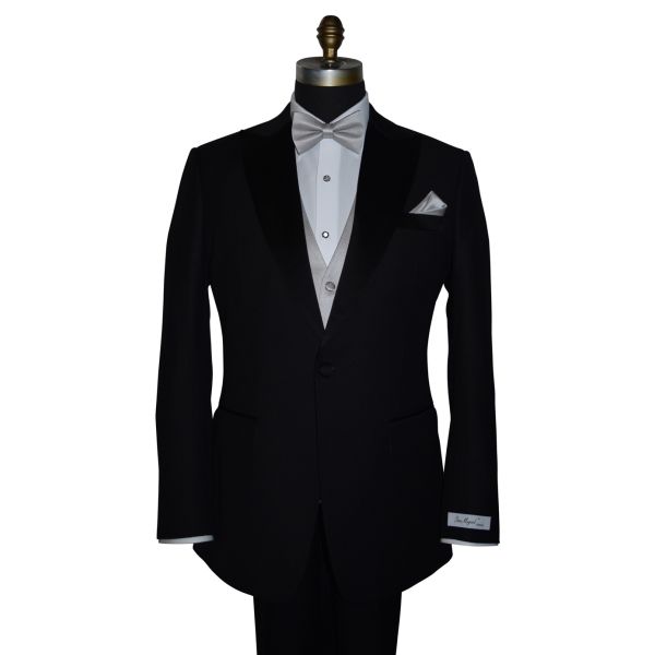  black tuxedo wearing a moonlight-gray "pre-tied" bowtie and vest with a tuxedo shirt and black tuxedo pants against a white background