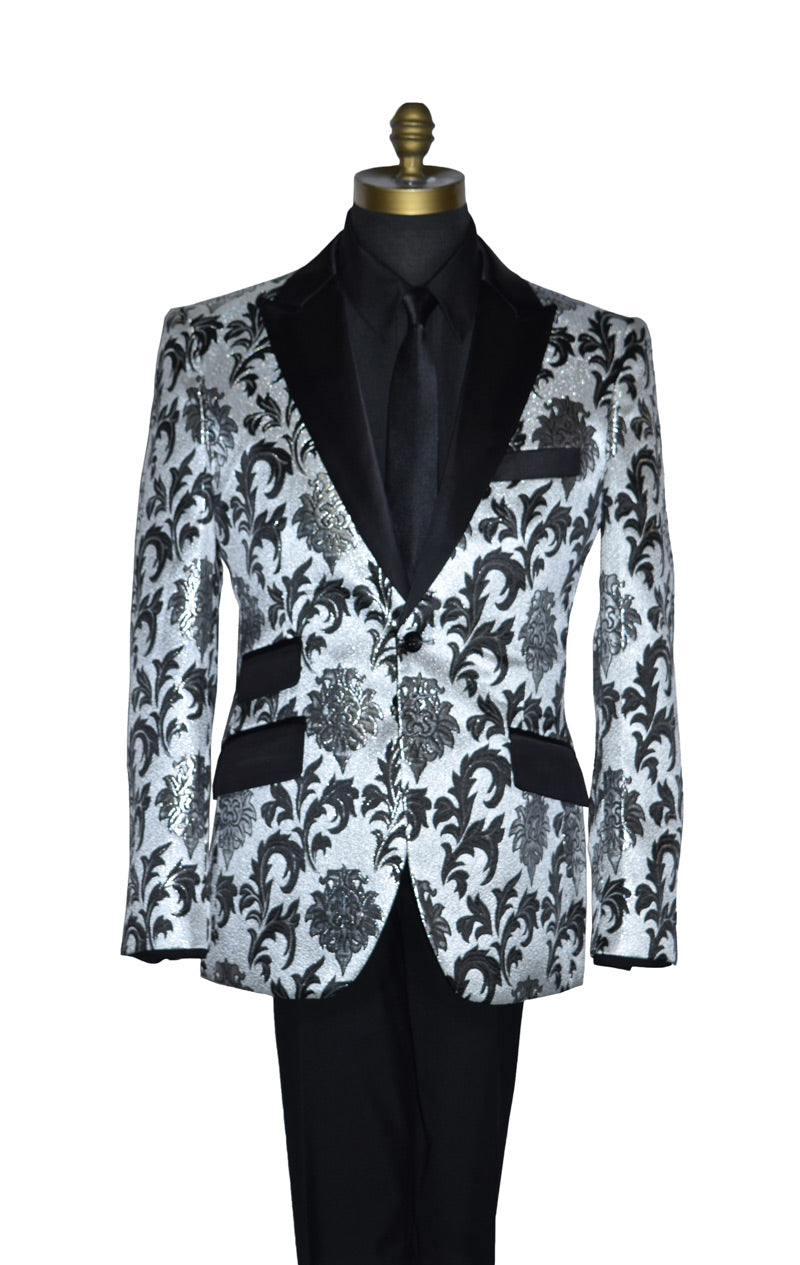 close-up silver and black tuxedo on a mannequin wearibng a black dress shirt and black necktie against a white background