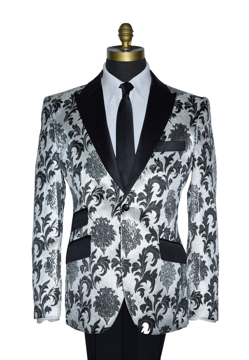close up silver and black peak lapel tuxedo wearing a black dress tie against a white background