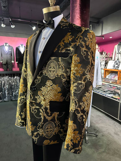 left side view of close up of a mannequin wearing a gold and black brocade tuxedo with black peak lapels inside a tuxedo shop