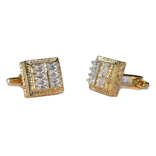 Gold cufflinks with clear gemstones on a white background