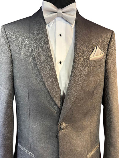 close-up of mannequin wearing a gray dinner jacket with slight print with a white tuxedo shirt and gray bowtie.