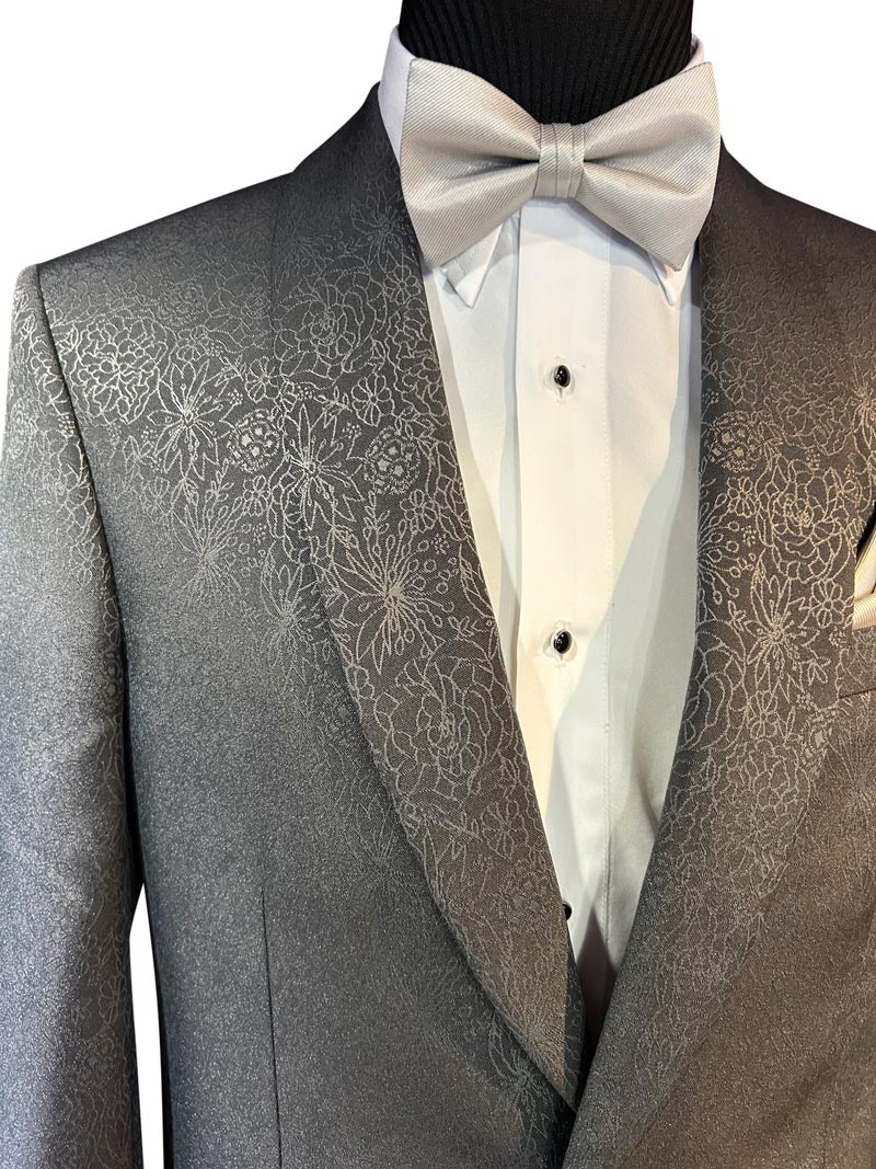 very close-up of gray dinner jacket with gray bowtie on a mannequin against a white background