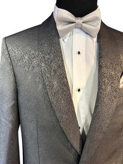 very close-up of gray dinner jacket with gray bowtie on a mannequin against a white background