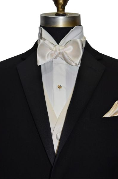 close-up mannequin wearing a black tuxedo with an ivory tuxedo shirt, an ivory vest abd an ivory "self-tie" bowtie against a white background