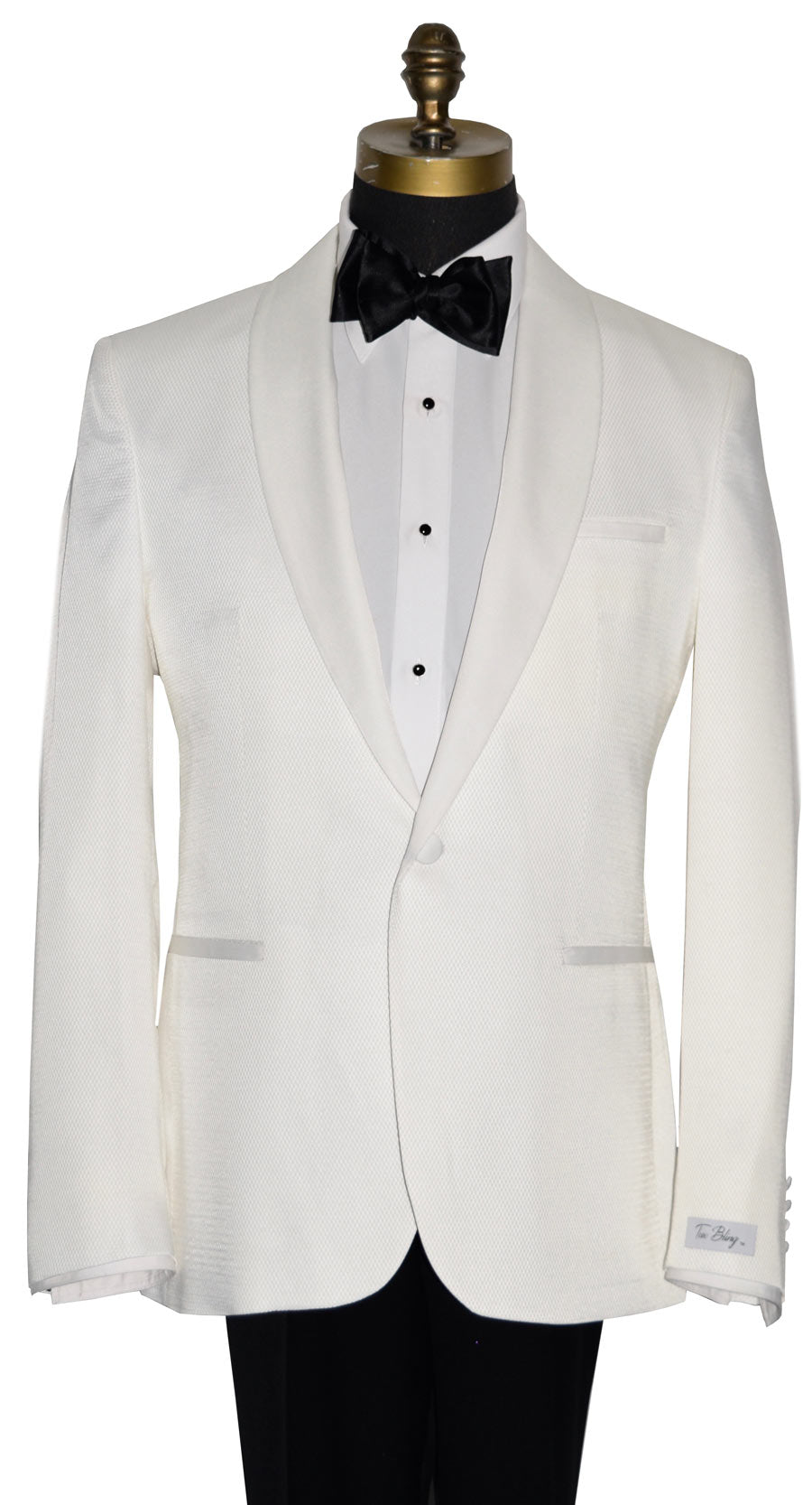 mannequin wearing an ivory shawl collar tuxedo with a white tuxedo shirt and a black  tie-yourself bowtie against a white background