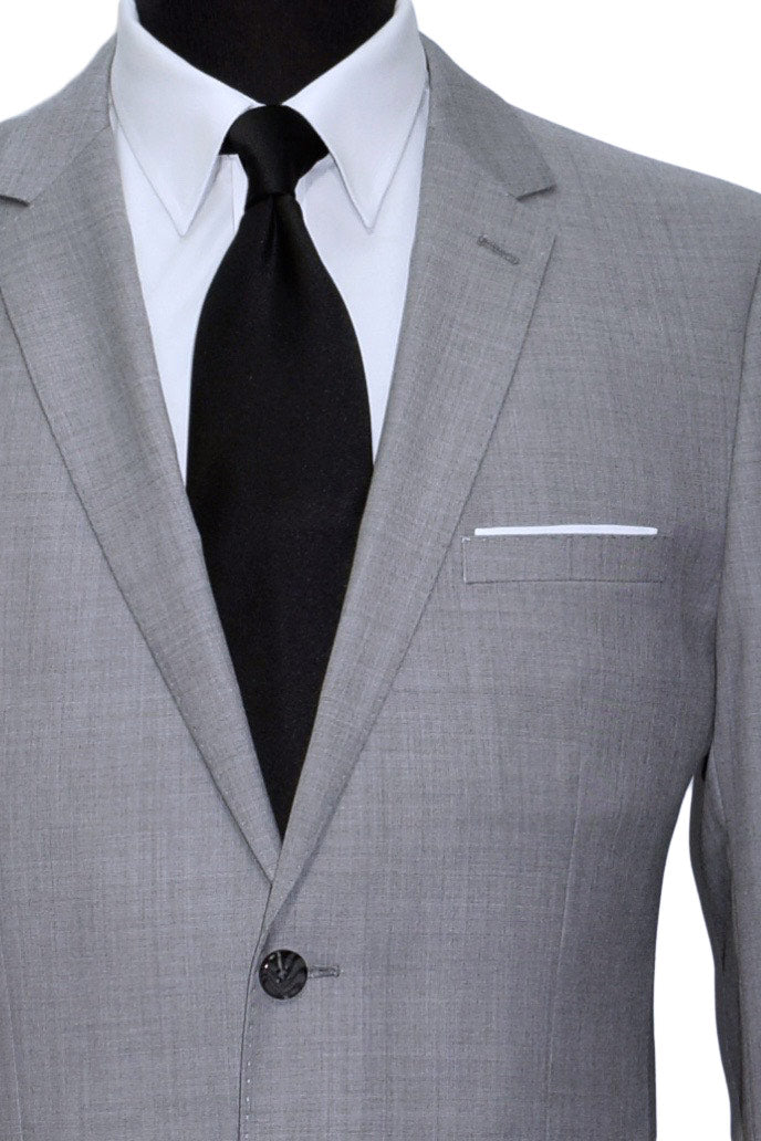close-up life size mannequin wearing a light gray mens suit  with a white dress shirt and a black sating necktie against a white background