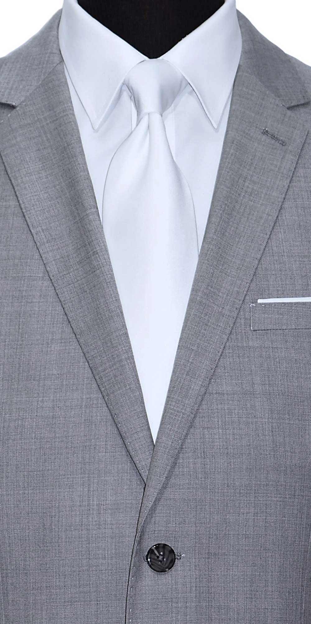 very close-up Life size mannequin wearing a light gray mens suit  with a white dress shirt and a white sating necktie against a white background