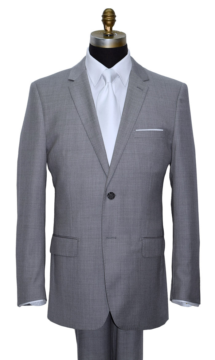 close-up Life size mannequin wearing a light gray mens suit  with a white dress shirt and a white sating necktie against a white background