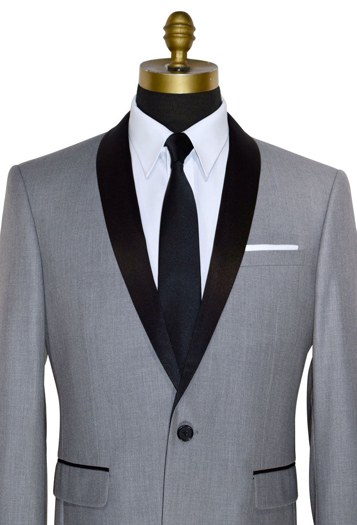 very close up mannequin wearing alight-gray shawl collar tuxedo with black necktie on a white background