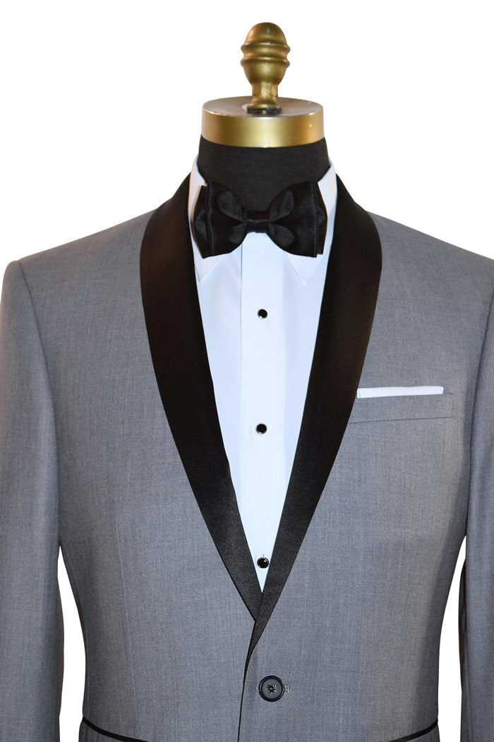 very close up mannequin wearing alight-gray shawl collar tuxedo with black bow tie on a white background